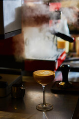 Cafe Latte or coffee Piccolo with heart shape of latte art in a martini glass or cocktail glass. Shallow dof.