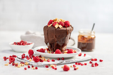 Raspberry mug cake in a glass on light background