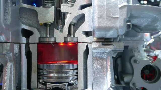 Inside view of engine, close up detail of two pistons in cylinder,some gears aside.