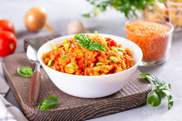 Red Lentil Soup with ingredients on light background. Traditional turkish or arabic lentil and vegetable spicy soup, healthy vegan food.