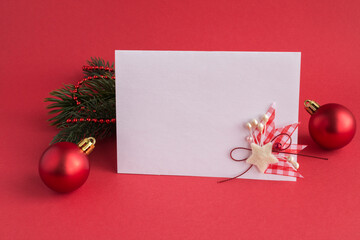 Closeup on blank white paper for Christmas greetings  on the red background copy space