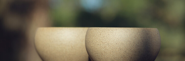 Ceramic bowls made of clay on a wooden background.