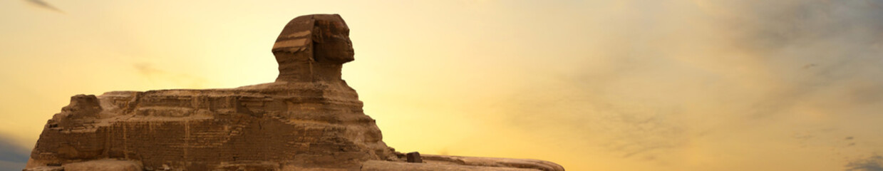 Fototapeta na wymiar Sphinx against the backdrop of the great Egyptian pyramids. Africa, Giza Plateau