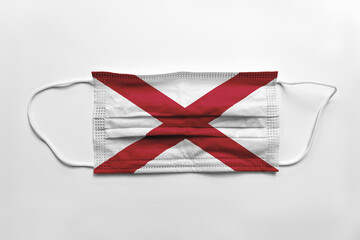 Face mask with Alabama flag printed, on white background, isolated