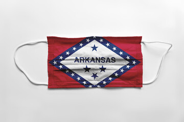 Face mask with Arkansas flag printed, on white background, isolated