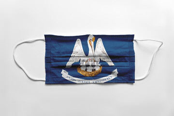 Face mask with Louisiana flag printed, on white background, isolated