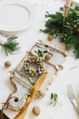 Stylish trending cutting Board with Cutlery, walnuts and a Christmas wreath of bells
