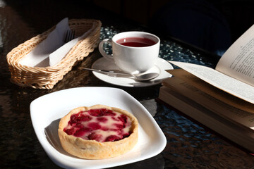 Morning the cafe, cup of espresso and berry dessert.
