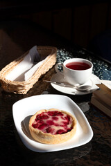 Morning the cafe, cup of espresso and berry dessert.