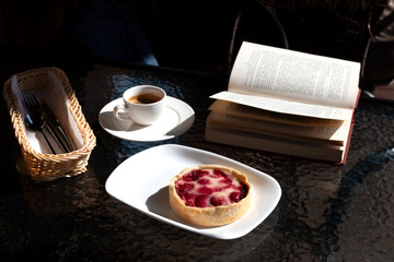 Morning the cafe, cup of espresso and berry dessert.