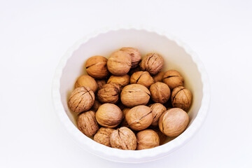 walnuts in a cup on a white background