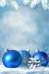 Christmas balls, snowflake and pine branch on winter background.
