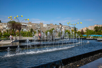 Fototapeta na wymiar Fountain in a new recreation park on the embankment of the city
