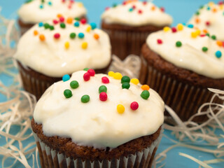 Carrot muffins with cream cheese frosting and sprinkles