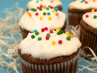 Carrot muffins with cream cheese frosting and sprinkles