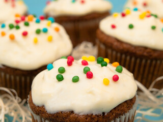 Carrot muffins with cream cheese frosting and sprinkles