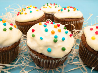 Carrot muffins with cream cheese frosting and sprinkles