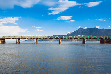 Long railway bridge on concrete supports across Lake Skadar in Montenegro - transport artery