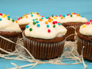 Carrot muffins with cream cheese frosting and sprinkles