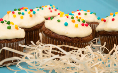Carrot muffins with cream cheese frosting and sprinkles
