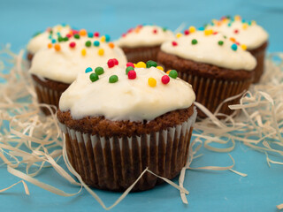 Carrot muffins with cream cheese frosting and sprinkles