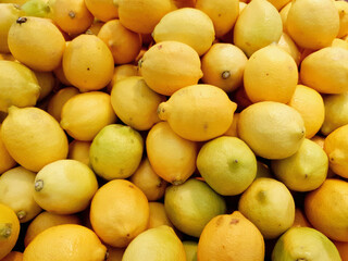 Yellow lemons for sale in supermarket. Lemon background, no people.