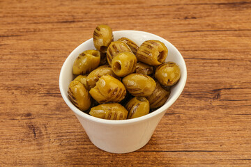 Green grilled olives in the bowl