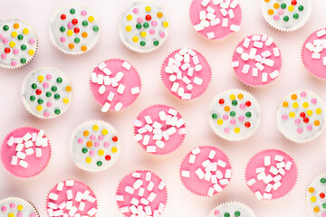 Colorful cupcakes on a white background.