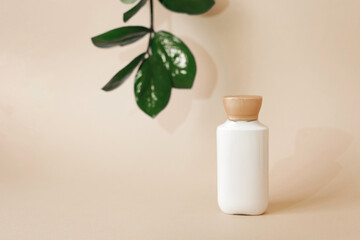 Natural organic cosmetic packaging plastic, layout with leaves in the background. The layout of the bottles for branding and labels.