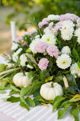 Table setting with beautiful autumn decorand with white mini pumpkins and crystal glasses for Thanksgiving Day or Halloween