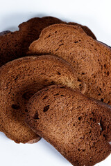 The texture of toasted pieces of bread. Croutons on a white background. Dark dry bread.