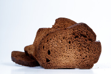 The texture of toasted pieces of bread. Croutons on a white background. Dark dry bread.
