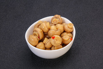 Pickled champignons in the bowl