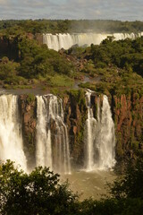 Obraz premium A rainbow over the huge Iguazu River and Waterfalls in Brazil and Argentina