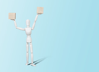 Mannequin with wooden cubes. Content completion concept. A mannequin on a blue pastel background is holding wooden empty cubes.