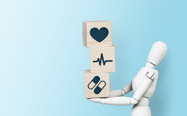Mannequin with wooden cubes with medical icons. Medical and pharmaceutical concept. Taking care of health, health care.