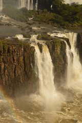 A rainbow over the huge Iguazu River and Waterfalls in Brazil and Argentina