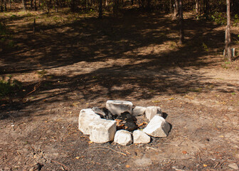 A place for a fire in the forest, lined with stones.