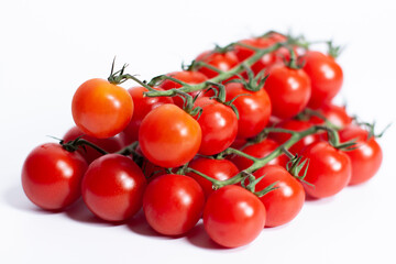 Clusters of cherry tomatoes on a white background. Side view.