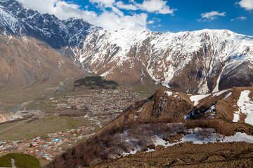 View of Stepantsminda townlet at sunny day