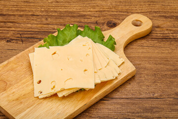 Sliced yellow cheese over board