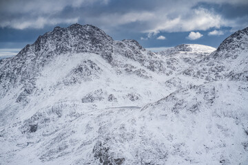 Fototapeta na wymiar Tryfan, Bristly Ridge and Y Foel Goch seen from Y Garn in Snowdonia National Park during winter.