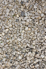 Grey stones and pebbles on the gorund in construction area. Pebbles texture background. 