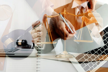 Business and lawyers discussing contract papers with brass scale on desk in office. Law, legal services, advice, justice and law concept picture with film grain effect