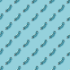 Blue shiny Christmas baubles on a blue pastel background. Christmas decorations. Minimal composition seamless pattern background. Christmas and New year concept. Top view, flat lay