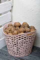 A basket with walnuts. Nearby is a white wooden box.