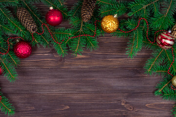 Fototapeta na wymiar Christmas tree with decoration on a dark wooden background. View from above. Place for an inscription. New Year. Christmas