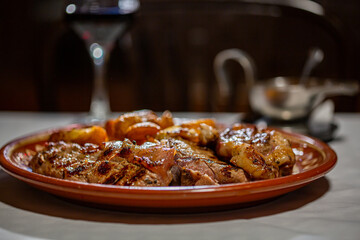 Meat and baked potatoes on a plate