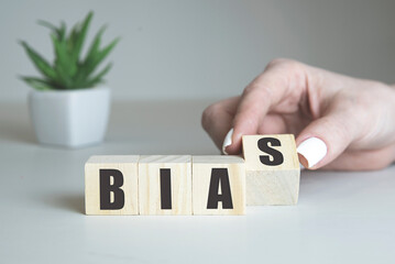 Bias - word from wooden blocks with letters, personal opinions prejudice bias concept, white...
