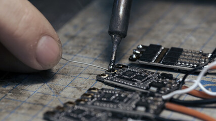 Man solder drone FPV motors speed controllers